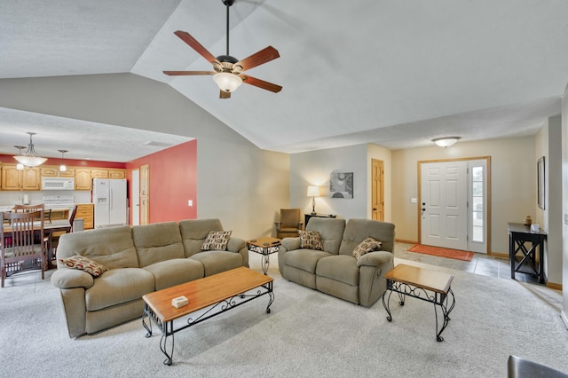 living area featuring light colored carpet, vaulted ceiling, and ceiling fan