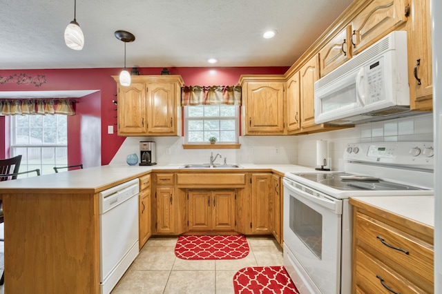 kitchen featuring white appliances, a sink, decorative backsplash, light countertops, and recessed lighting