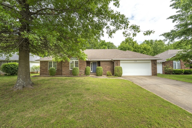 single story home with a garage, brick siding, concrete driveway, a front yard, and a shingled roof