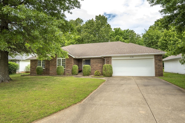 ranch-style home featuring brick siding, an attached garage, concrete driveway, and a front lawn
