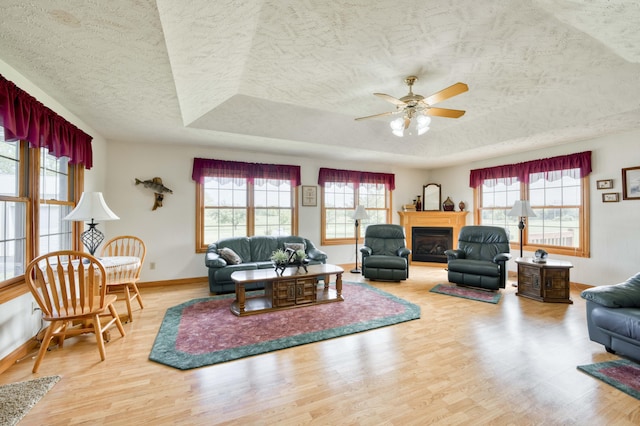 9169 W Farm Road 60, Willard, MO 65781 - living area featuring a textured ceiling, wood finished floors, a ceiling fan, and baseboards