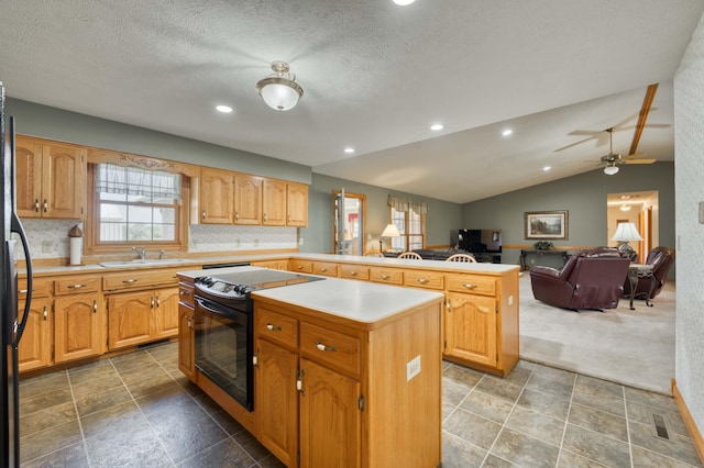 9169 W Farm Road 60, Willard, MO 65781 - kitchen featuring a kitchen island, a sink, a peninsula, open floor plan, and black appliances
