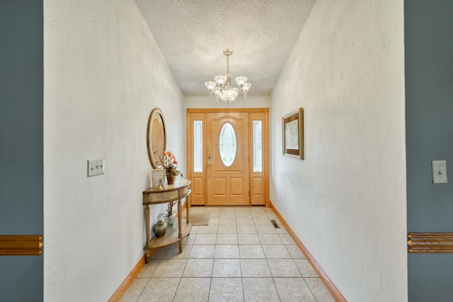 9169 W Farm Road 60, Willard, MO 65781 - foyer entrance with a chandelier, a textured ceiling, a textured wall, baseboards, and light tile patterned flooring