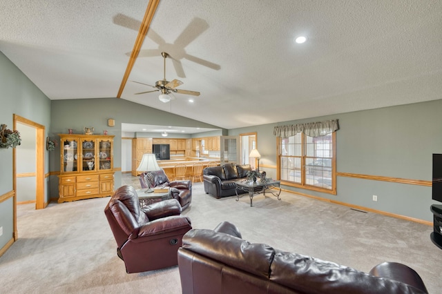 9169 W Farm Road 60, Willard, MO 65781 - living room featuring light carpet, ceiling fan, a textured ceiling, vaulted ceiling, and baseboards