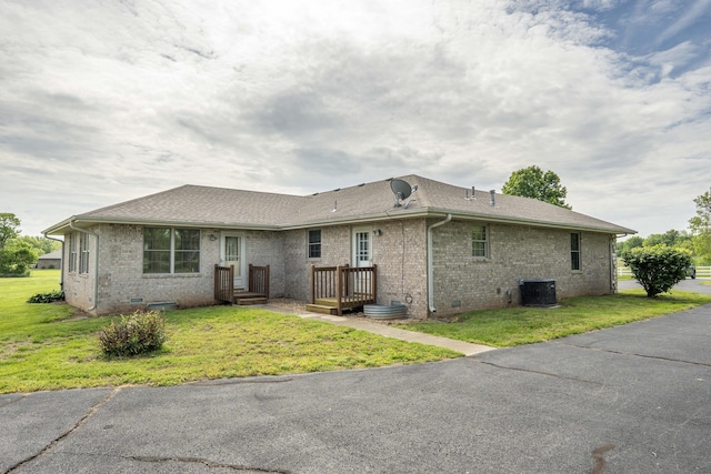 9169 W Farm Road 60, Willard, MO 65781 - back of property with brick siding, central AC, and a lawn