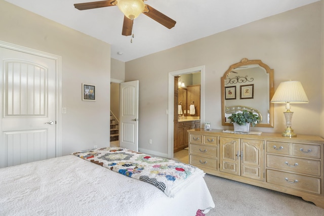 122 Arabian Way, Saddlebrooke, MO 65630 - bedroom with light colored carpet, ensuite bathroom, a ceiling fan, and baseboards
