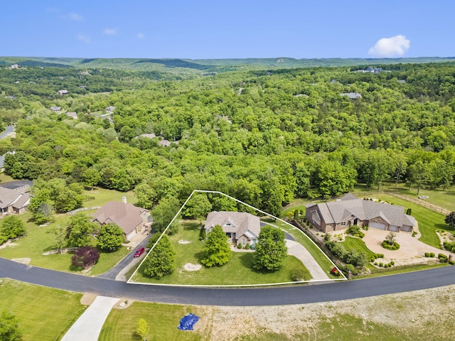 122 Arabian Way, Saddlebrooke, MO 65630 - aerial overview of property's location featuring a heavily wooded area and property parcel outlined