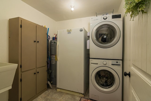 4216 Skyline Rd, Seymour, MO 65746 - laundry room featuring stacked washer / dryer, cabinet space, water heater, and light tile patterned floors
