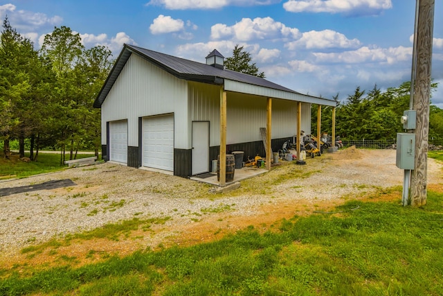 4216 Skyline Rd, Seymour, MO 65746 - view of side of property with an outdoor structure, fence, metal roof, and a garage