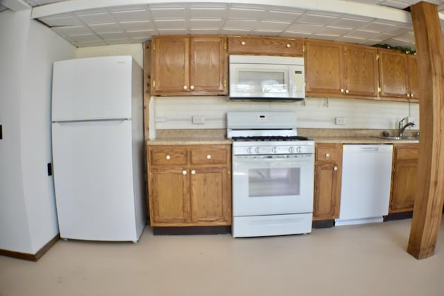70 Dallion Ford Ln, Buffalo, MO 65622 - kitchen featuring white appliances, light countertops, brown cabinetry, a sink, and baseboards