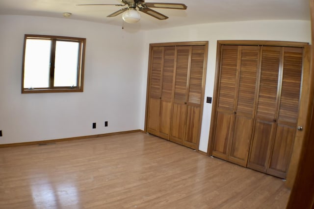 70 Dallion Ford Ln, Buffalo, MO 65622 - unfurnished bedroom with multiple closets, light wood-style flooring, baseboards, and ceiling fan