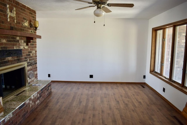 70 Dallion Ford Ln, Buffalo, MO 65622 - unfurnished living room featuring a brick fireplace, wood finished floors, ceiling fan, and baseboards