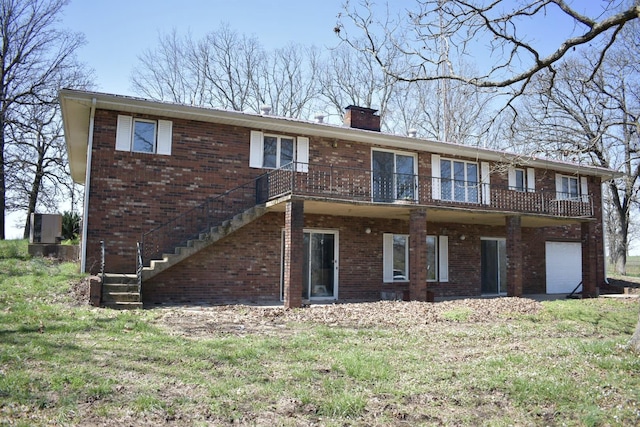70 Dallion Ford Ln, Buffalo, MO 65622 - rear view of house featuring brick siding, a chimney, stairway, and an attached garage