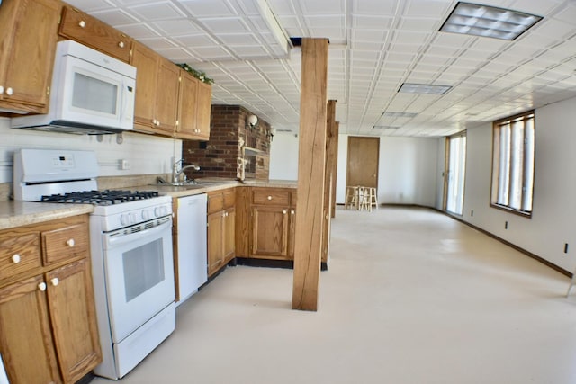 70 Dallion Ford Ln, Buffalo, MO 65622 - kitchen with white appliances, a sink, light countertops, brown cabinets, and tasteful backsplash