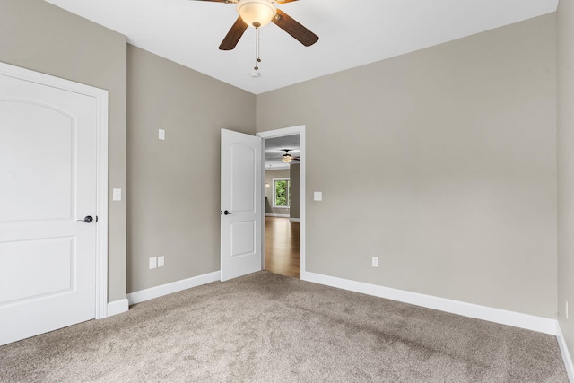 311 Stillwood Dr, Branson, MO 65616 - unfurnished bedroom with carpet floors, baseboards, and ceiling fan