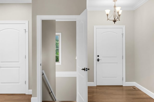 311 Stillwood Dr, Branson, MO 65616 - foyer featuring a chandelier, wood finished floors, crown molding, and baseboards