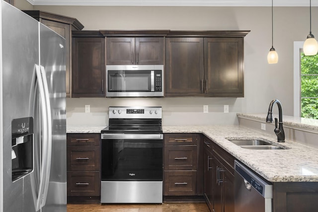 311 Stillwood Dr, Branson, MO 65616 - kitchen with appliances with stainless steel finishes, a sink, dark brown cabinets, dark wood-type flooring, and a peninsula