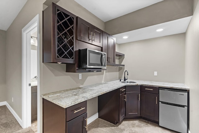 311 Stillwood Dr, Branson, MO 65616 - kitchen with fridge, stainless steel microwave, dark brown cabinetry, open shelves, and recessed lighting