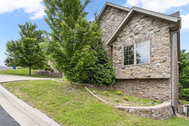 311 Stillwood Dr, Branson, MO 65616 - view of side of home with stone siding and a lawn