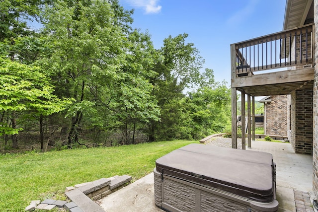 311 Stillwood Dr, Branson, MO 65616 - view of green lawn with a hot tub, a patio, and a wooden deck