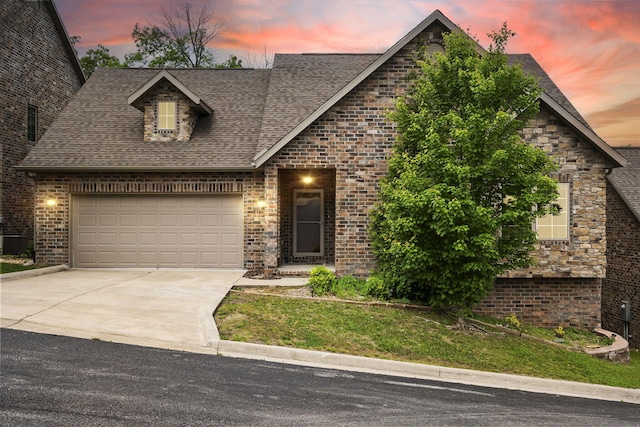 311 Stillwood Dr, Branson, MO 65616 - view of front facade featuring concrete driveway, roof with shingles, an attached garage, and brick siding