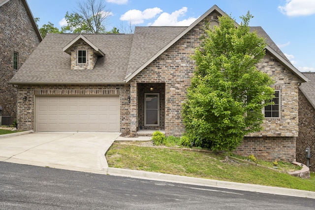 311 Stillwood Dr, Branson, MO 65616 - view of front facade with brick siding, concrete driveway, a garage, and a shingled roof
