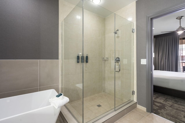 2513A Branson Landing Blvd, Branson, MO 65616 - ensuite bathroom with a stall shower, tile patterned floors, a soaking tub, and a ceiling fan