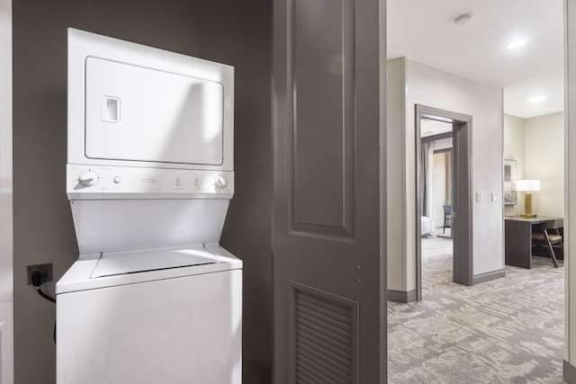 2513A Branson Landing Blvd, Branson, MO 65616 - laundry room with stacked washer / dryer, light carpet, and baseboards