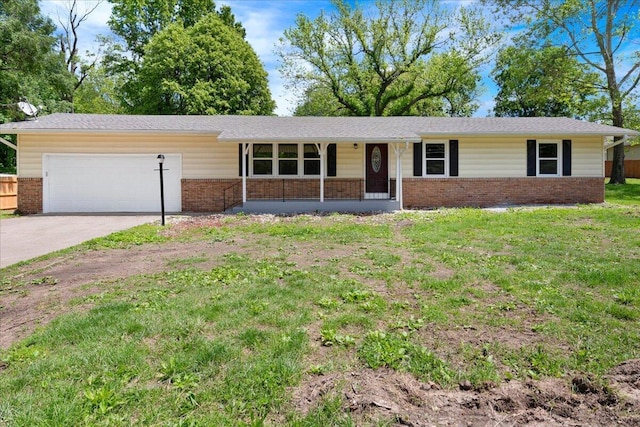 3156 N National Ave, Springfield, MO 65803 - ranch-style home with brick siding, an attached garage, concrete driveway, and a front yard