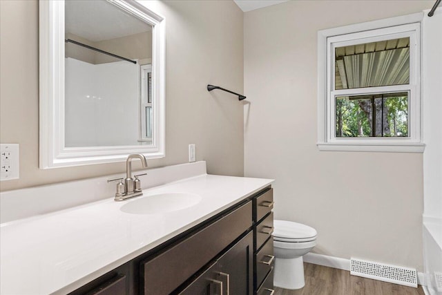 3156 N National Ave, Springfield, MO 65803 - bathroom with wood finished floors, vanity, toilet, and baseboards