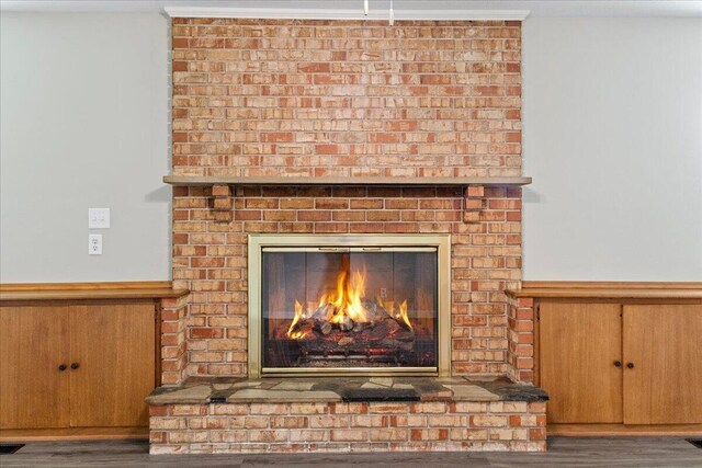 3156 N National Ave, Springfield, MO 65803 - detailed view of a brick fireplace, wainscoting, and wood finished floors