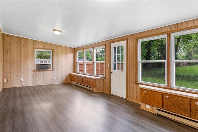 3156 N National Ave, Springfield, MO 65803 - unfurnished room with baseboard heating, a baseboard radiator, dark wood-type flooring, wooden walls, and cooling unit