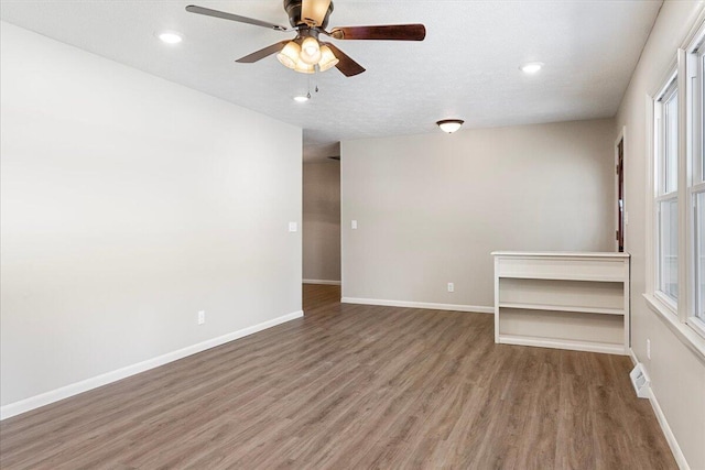 3156 N National Ave, Springfield, MO 65803 - unfurnished room featuring wood finished floors, ceiling fan, baseboards, and recessed lighting