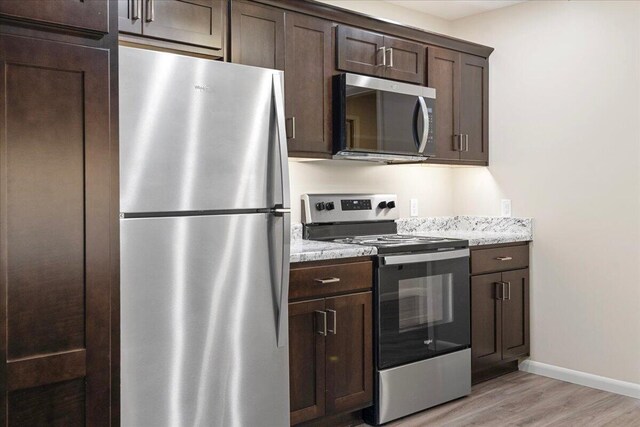 3156 N National Ave, Springfield, MO 65803 - kitchen with stainless steel appliances, dark brown cabinets, light wood-style flooring, and baseboards