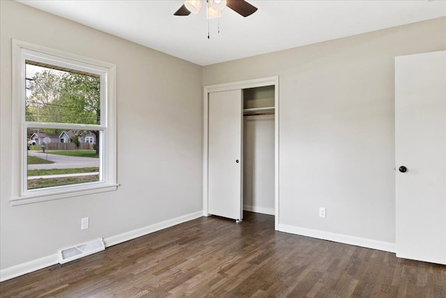3156 N National Ave, Springfield, MO 65803 - unfurnished bedroom featuring wood finished floors, baseboards, a closet, and a ceiling fan