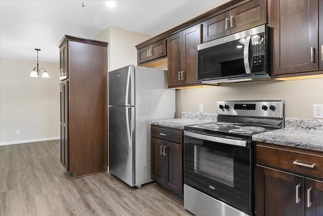 3156 N National Ave, Springfield, MO 65803 - kitchen with stainless steel appliances, light wood finished floors, dark brown cabinetry, and a chandelier