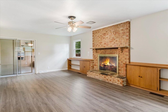 3156 N National Ave, Springfield, MO 65803 - unfurnished living room featuring wood finished floors, a fireplace, and ceiling fan