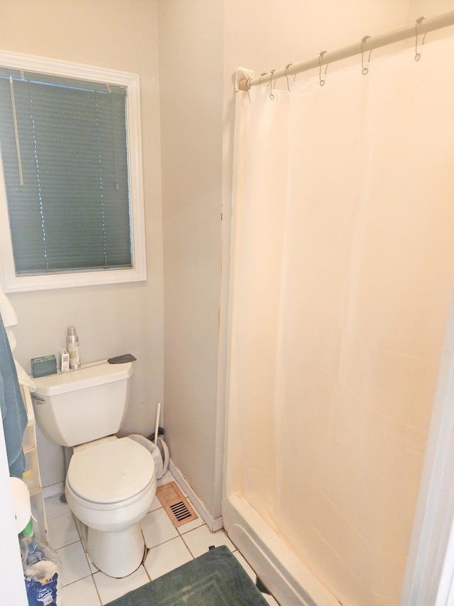 2016 Timberlake Rd, Branson, MO 65616 - full bathroom featuring a stall shower, toilet, tile patterned flooring, and baseboards