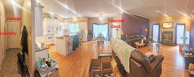 2016 Timberlake Rd, Branson, MO 65616 - living room featuring ceiling fan, light wood-style flooring, a tile fireplace, and crown molding