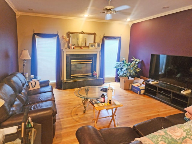 2016 Timberlake Rd, Branson, MO 65616 - living area featuring a ceiling fan, wood finished floors, ornamental molding, and a tile fireplace