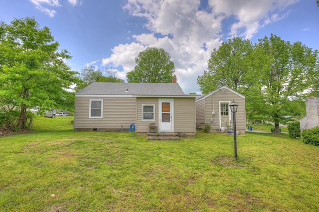817 Kentland Dr, Neosho, MO 64850 - rear view of property featuring a yard, entry steps, an outbuilding, and roof with shingles