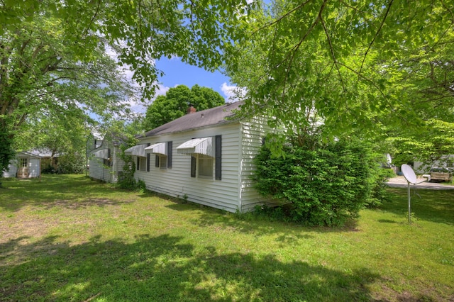 720 Kentland Dr, Neosho, MO 64850 - view of green lawn with an outdoor structure and a storage shed
