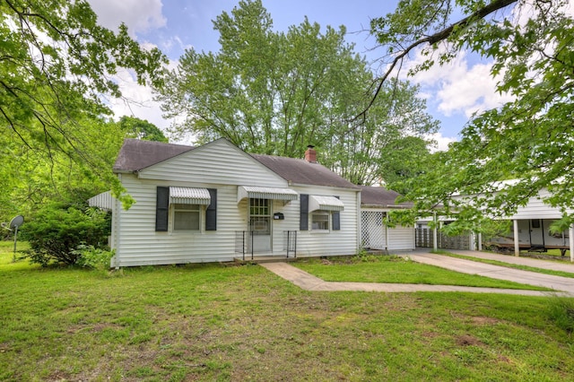 720 Kentland Dr, Neosho, MO 64850 - bungalow-style home featuring a front yard, concrete driveway, a chimney, and roof with shingles