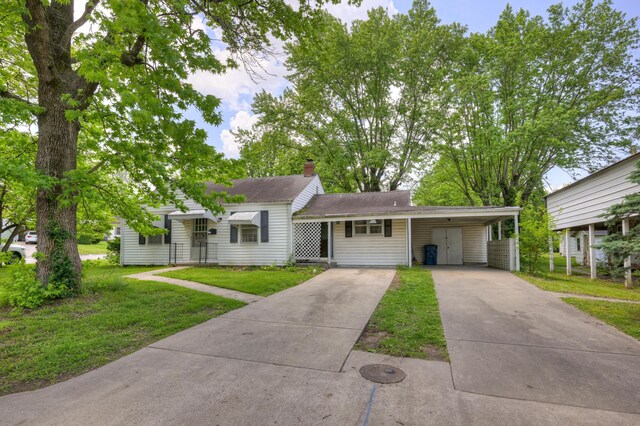 720 Kentland Dr, Neosho, MO 64850 - view of front of property with a front yard, driveway, a carport, and a chimney