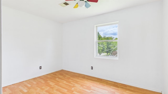 unfurnished room with ceiling fan, baseboards, and light wood finished floors