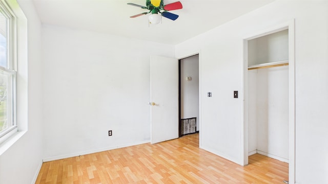 unfurnished bedroom with light wood-style floors, a closet, and baseboards