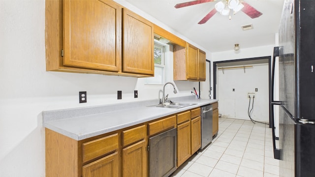 kitchen featuring a sink, freestanding refrigerator, ceiling fan, stainless steel dishwasher, and light countertops