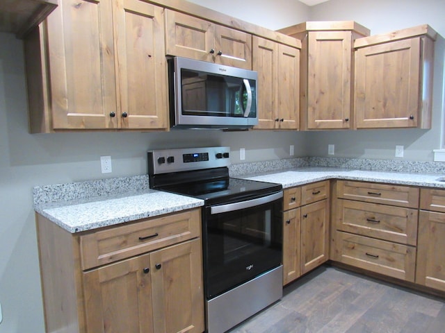 748 Birdsong Ln, Marshfield, MO 65706 - kitchen with appliances with stainless steel finishes, dark wood-style floors, and light stone countertops