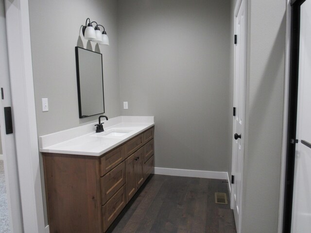 748 Birdsong Ln, Marshfield, MO 65706 - bathroom featuring vanity, wood finished floors, and baseboards