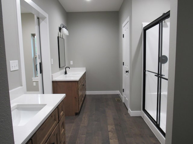 748 Birdsong Ln, Marshfield, MO 65706 - full bath featuring wood finished floors, a stall shower, two vanities, and baseboards
